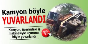 Kamyon, üzerindeki iş makinesi ile uçuruma böyle yuvarlandı