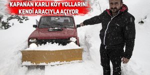 Kapanan karlı köy yolları kendi aracıyla açıyor