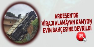 Ardeşen’de virajı alamayan kamyon evin bahçesine devrildi