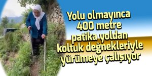 Yolu olmayınca 400 metre patika yoldan koltuk değnekleri ile yürüyor